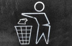 An icon showing a person disposing of waste